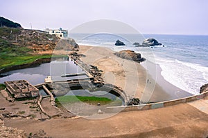 Ruins of the Sutro baths on a cloudy day; the Cliff house in the background, Lands End, San Francisco, California