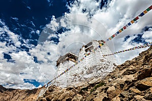 Ruins of Tsemo Victory Fort on the cliff of Namgyal hill and Lungta - colorful Buddhist prayer flags