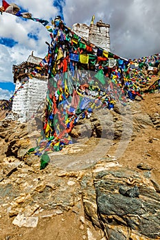 Ruins of Tsemo Victory Fort on the cliff of Namgyal hill and Lungta - colorful Buddhist prayer flags