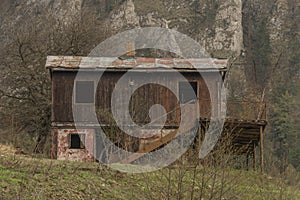 Ruins of wooden house in Vrsatec village in spring dark cloudy day