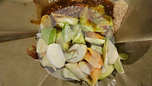 Rujak buah or indonesian mixed fruit salad, served with spicy brown sugar sauce and ground peanuts photo