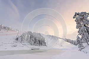 Rukatunturi ski jumping hill in winter season and nice weather and blue sky in winter season and sunset time at Ruka ski