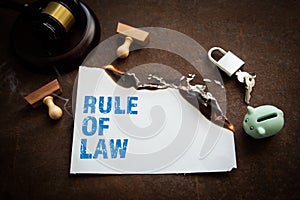 Rule of Law concept. Burning sheet of paper on a rusty metal background