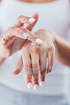 Rule number one Moisturize. an unrecognizable woman applying moisturizer.