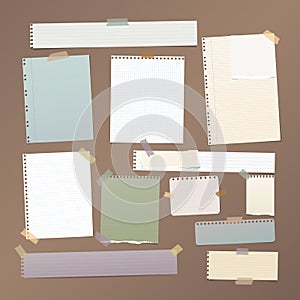 Ruled, squared note, notebook, copybook paper strips, sheets stuck with sticky tape on brown background.
