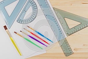 Ruler Combo Set, Ruler, Protractor, Triangle, Brush Set, and Paper. Top View, Close Up