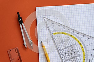 Ruler, compass, pencil at open notepad. Accessories for learning mathematics. Education, Back to school concept.