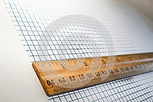 a ruler on graph grid paper at an angle isolated on a white background math theme. stem science enginnering technology math photo