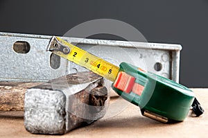 Ruler, hammer and level on the shelf