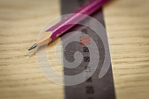 Ruler and pencil on a wooden background. Part marking. Carpenter`s workshop. Work carpenter.