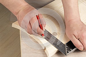 Ruler and pencil on a wooden background. Part marking. Carpenter`s workshop. Work carpenter