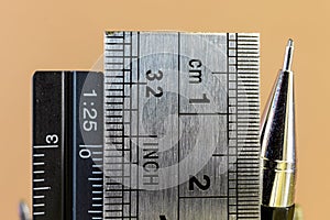 Rulers and mechanical pencil macro image in yellow background.