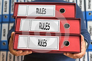 Rules, Rules, Rules concept words. Folder concept. Ring binders.