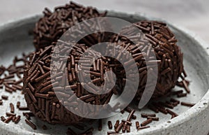 Rum balls with chocolate sprinkles in a bowl