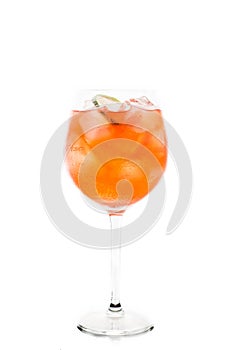 Rum based red cocktail with lime in wine glass isolated on white background
