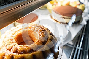 Rum cake. Showcase desserts in an Italian cafe or trattoria. Variety of cakes on display.