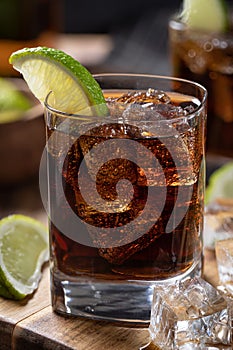 Rum and cola cocktail with sliced lime