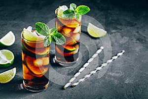 Rum and Cola Cuba Libre ice cold drink cocktail with lime and mint
