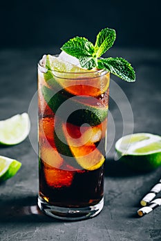 Rum and Cola Cuba Libre ice cold drink cocktail with lime and mint