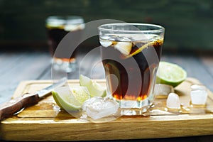 Rum and cola refreshing Cuba Libre alcohol cocktail with lime an