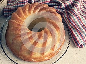 Rum-soaked circular cake Savarin. Freshly-baked rum baba. Yeasted cake baked in a ring mold