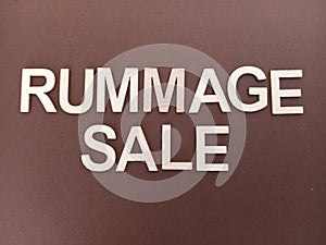 Rummage sale sign on a brown background photo