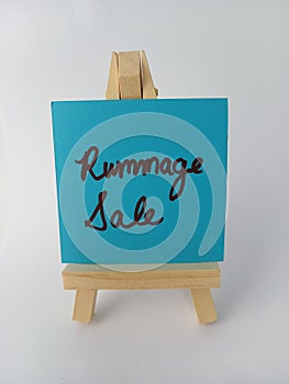 Rummage sale sign on a wood easel on a white background photo