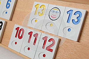 Rummy game formations arranged on the board in selective focus. Wooden board with sets of numbers