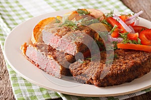 Rump steak in breadcrumbs and fresh vegetables, baked potatoes c