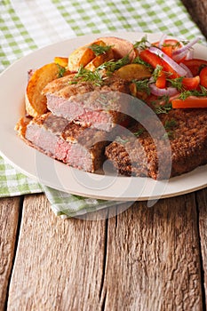 Rump steak in breadcrumbs and fresh vegetables, baked potatoes c