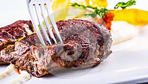 Rump steak. Close up Tender Grilled Beef Meat on White Plate with vegetable decoration.