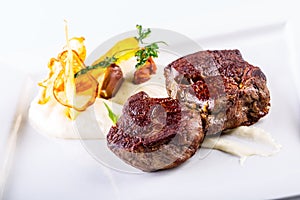 Rump steak. Close up Tender Grilled Beef Meat on White Plate with vegetable decoration.