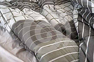 Rumpled bed comforter and sheets