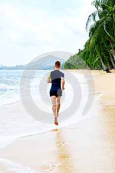 Run. Fit Athletic Man Running On Beach. Exercising. Healthy Life