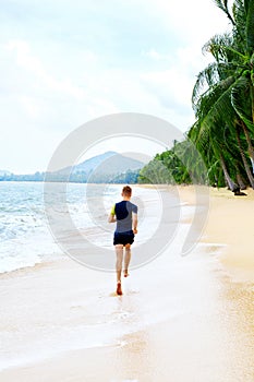 Run. Fit Athletic Man Running On Beach. Exercising. Healthy Life