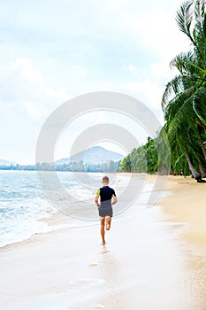 Run. Fit Athletic Man Running On Beach. Exercising. Healthy Life