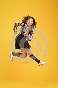 Run for fun. Happy kid have fun yellow background. Little child in midair. School holidays. Play and fun. Free times