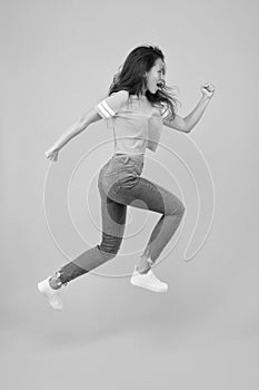 Run hard to arrive at goal. Dynamic woman run yellow background. Sexy girl jump with long run. Energetic look of fashion