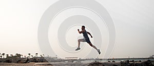 Run hard or walk home. Running man on beach. Runner training outdoors. Fit male sport fitness exercising in summer