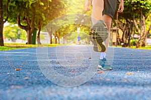 Run jogging exercise uplift leg and foot for health lose weight concept on track rubber public park