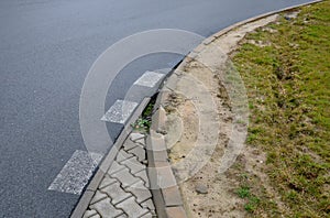 Run-over edges with tracks from heavy trucks. a poorly designed turn radius means damage to curbs, concrete paving. damaged lawn d
