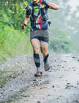 Run rain,Cross country runner,Trail running in the forest,uphill in autumn trail of mud and stones,In the north of Thailand,blur,S