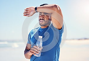 That run was super intense. Shot of a man holding a bottle water while looking exhausted during his run.