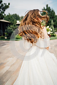 runaway bride. A beautiful woman in a white wedding dress with flowing hair