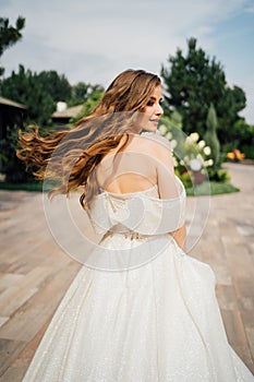 runaway bride. A beautiful woman in a white wedding dress with flowing hair