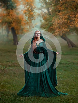 Runaway princess with red blond long hair dressed in a green emerald expensive velvet royal cloak-dress with a precious