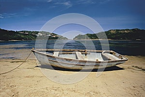 Rundown rowboat on beach photo