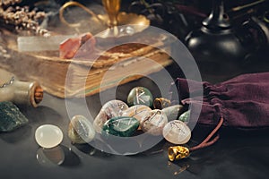 Rune Stones, Old Book and Crystals on Black