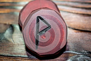 Rune Wynn Wen red color carved from wood on a wooden background
