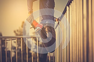 Runer stretching at sunset